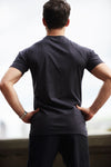 Back view picture of man in a black Sole Ambition athletic t-shirt, posing for the camera