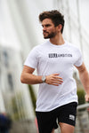 Man running with a white sole ambition t shirt and black shorts
