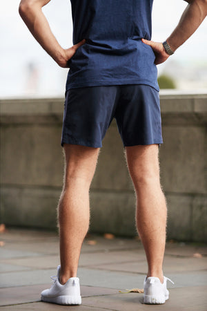 Back view of man wearing men's navy athletic workout shorts from Sole Ambition